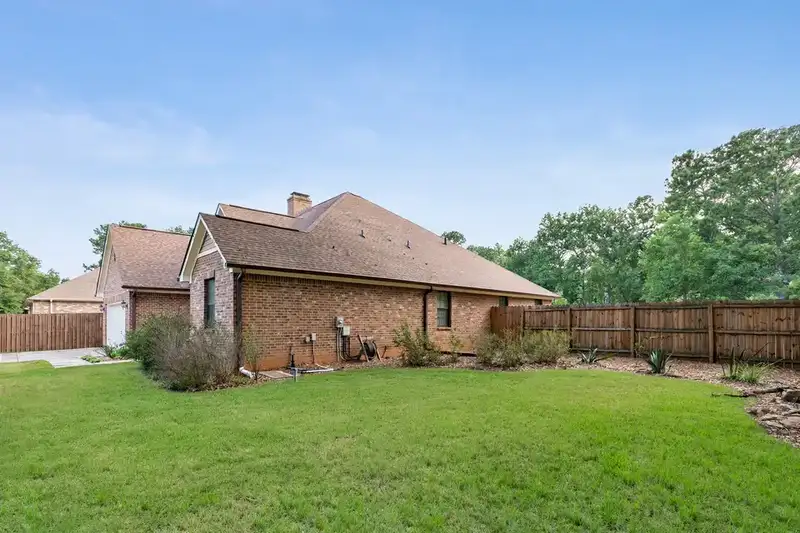Residential yard after the tree and stump are removed and the lawn is restored